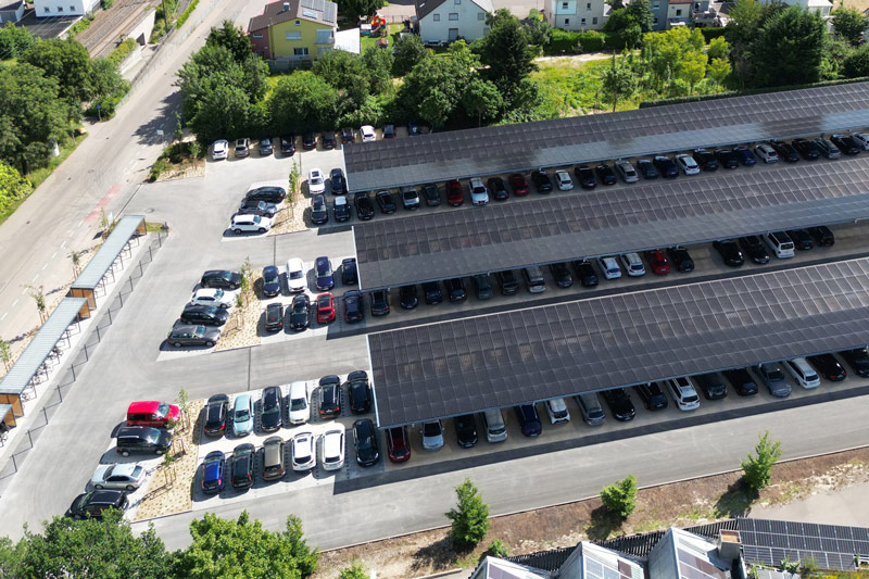 The picture shows the new parking lot with solar panels on the roof.